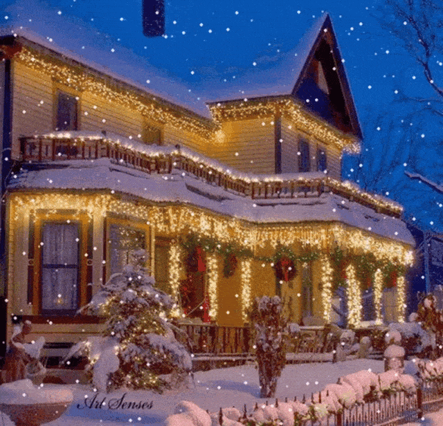 Two story house with White Christmas lights, Christmas wreaths, and snow.