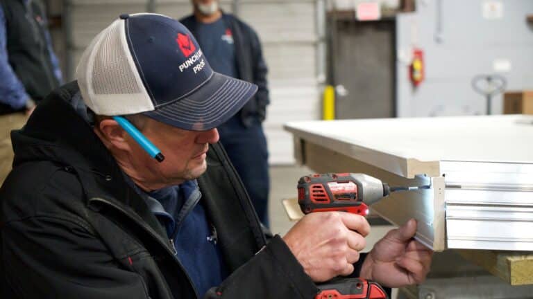 handyman completing work on a door before installation