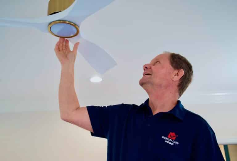 handyman fixing a ceiling fan