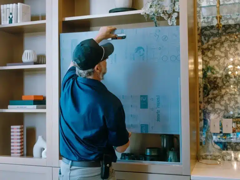 Cabinet Door Repair 1 Professional fixing a misaligned or damaged cabinet door in a kitchen, restoring proper function and appearance