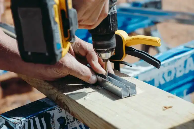 Drawer Track Repair & Replacement 1 Close-up of a worker repairing a kitchen drawer track, ensuring smooth operation and extending the life of cabinetry.